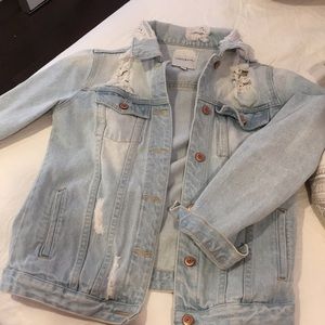Distressed light wash denim jacket